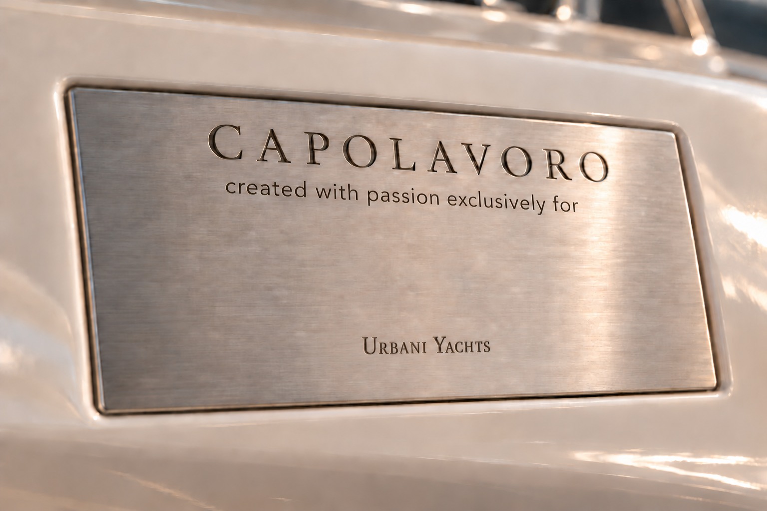 A Capolavoro dedication plaque recessed into ivory yacht fiberglass, engraved with ‘created with passion exclusively for’, a space for the owner's name, and the Urbani Yachts logo.